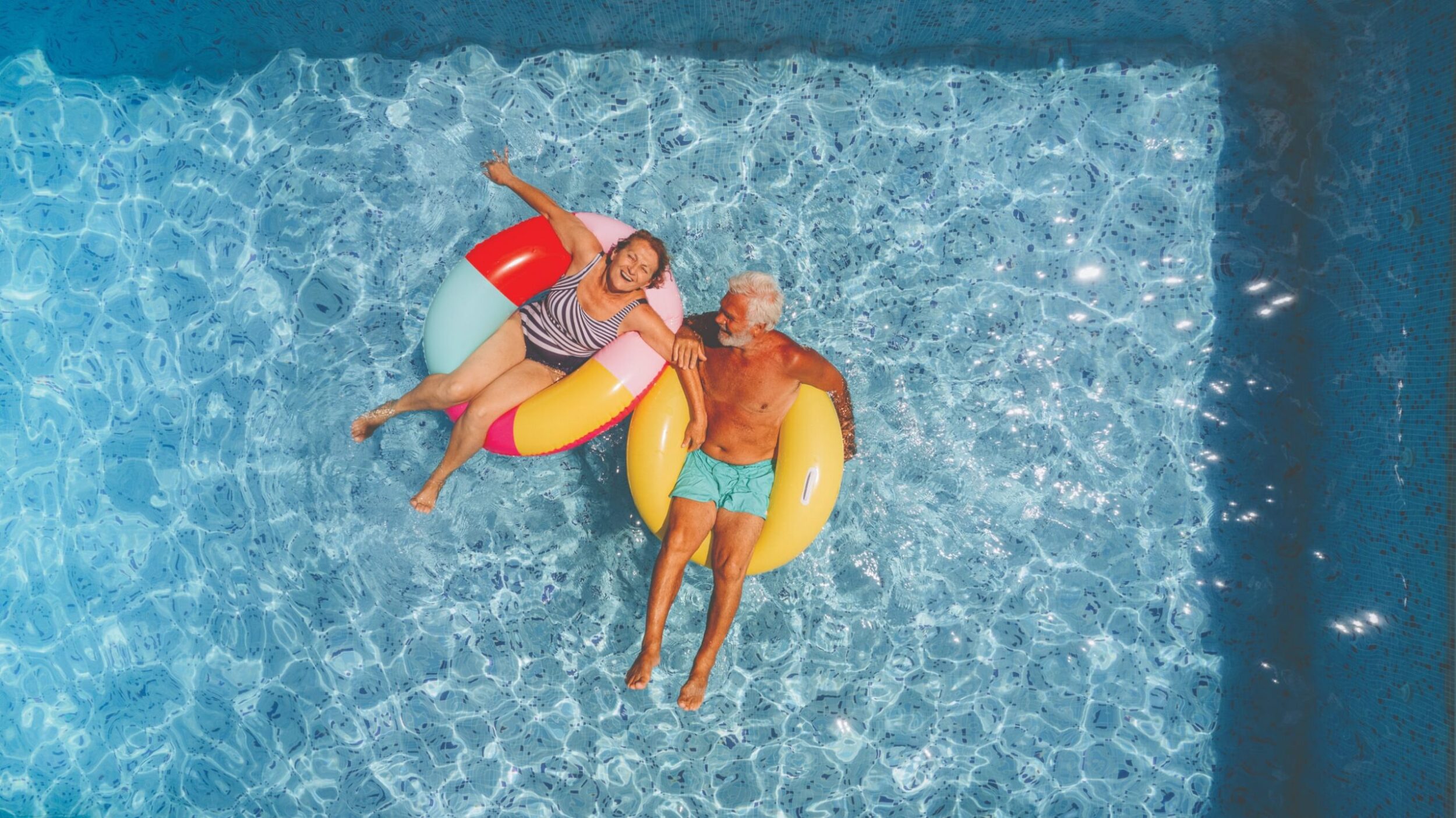 Two people enjoying a pool